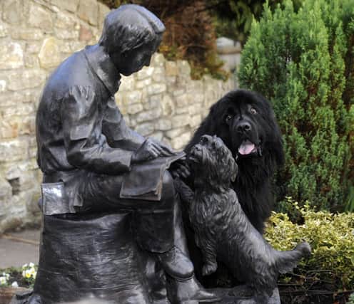 Paddy the dog has a look at the statue of Robert Louis Stevenson in Colinton. Picture: Greg Macvean