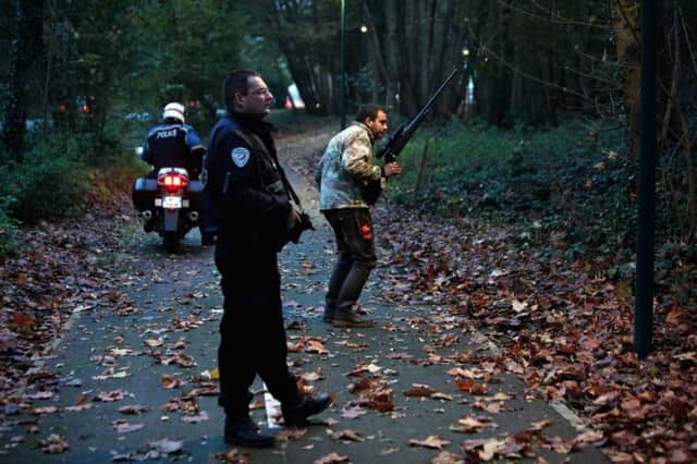 Armed police hunt the big cat at Montevrain, near Disneyland Paris. Picture: AP