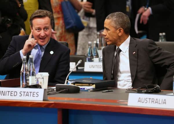 Prime Minister David Cameron gestures as he talks with US President Barack Obama in Brisbane, Australia. Picture: AP