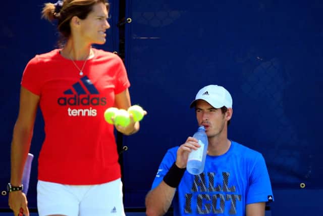 Andy Murray drinks water as he practices with his coach, Amelie Mauresmo. Picture: Getty