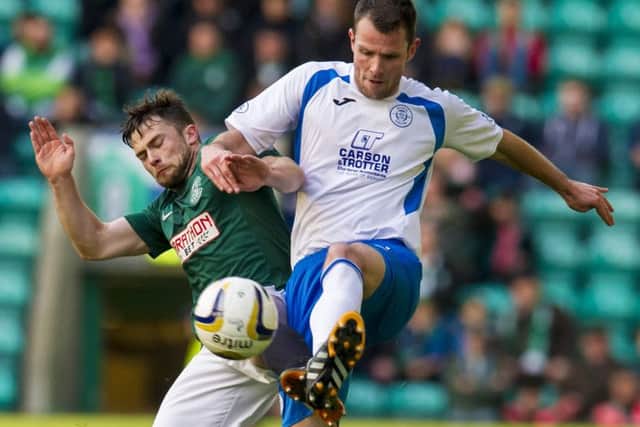 Hibernian's Lewis Stevenson (left) challenges Andy Dowie. Picture: SNS