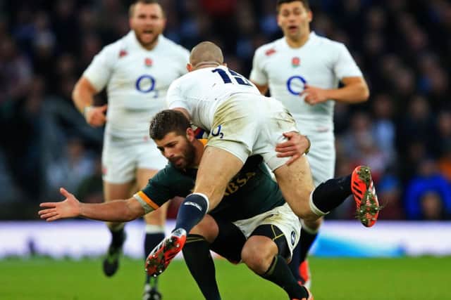 Mike Brown of England gets a firemans lift from Springbok Willie Le Roux, continuing his afternoon of heavy lifting at Twickenham.  Picture:  David Cannon/Getty Images