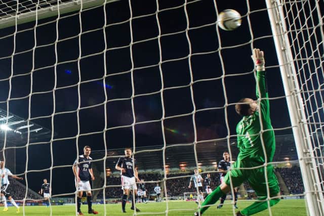Kevin McHattie fires a stunner past former Hearts goalkeeper Jamie MacDonald to put his side in front against Falkirk yesterday. Photograph: Rob Casey/SNS
