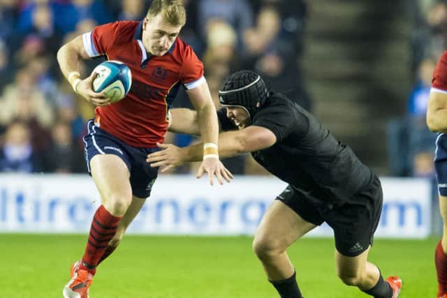 Scotland's Stuart Hogg (left) drives forward. Picture: SNS