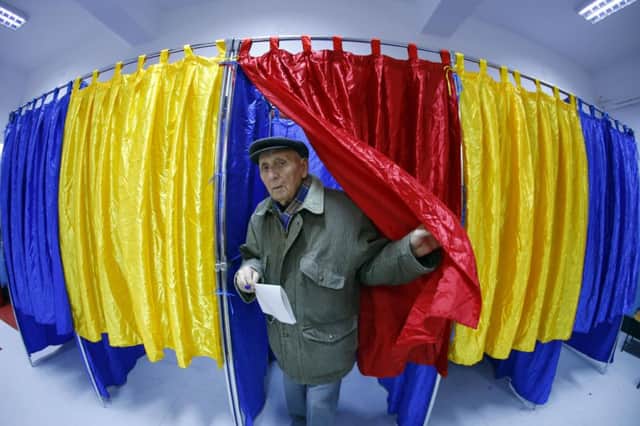A voter leaves a Bucharest polling station where high turnout was expected. Picture: Reuters