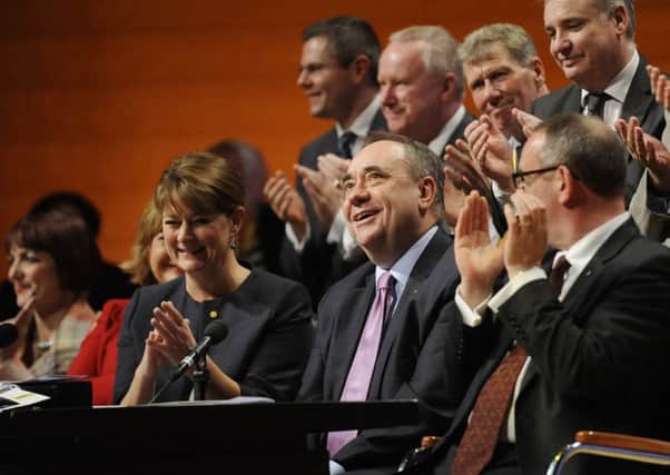 Alex Salmond reacts to being given a standing ovation at yesterday's SNP conference. Picture: Greg Macvean