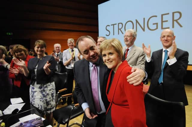 Alex Salmond embraces his successor at the conference; few political partnerships are so close. Picture: Greg Macvean