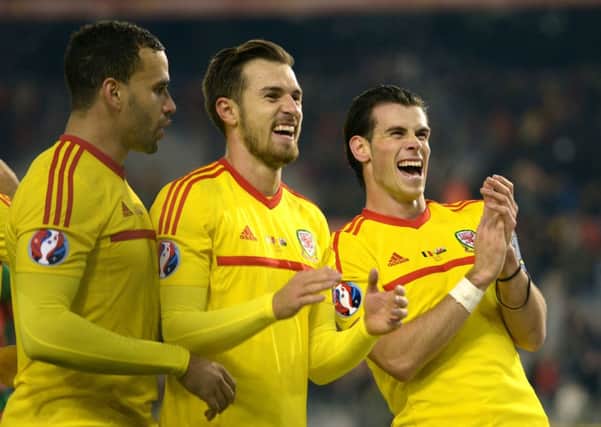 Wales Hal Robson-Kanu, Aaron Ramsey and Gareth Bale applaud the fans after clinching a 0-0 draw with Belgium. Picture: PA