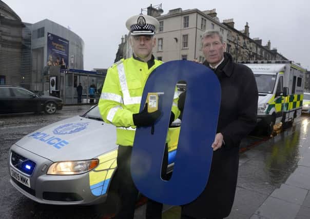 Kenny MacAskill, right, and Chief Superintendent Iain Murray promote the lower drink-drive limit, which comes into force next month. Picture: Julie Bull