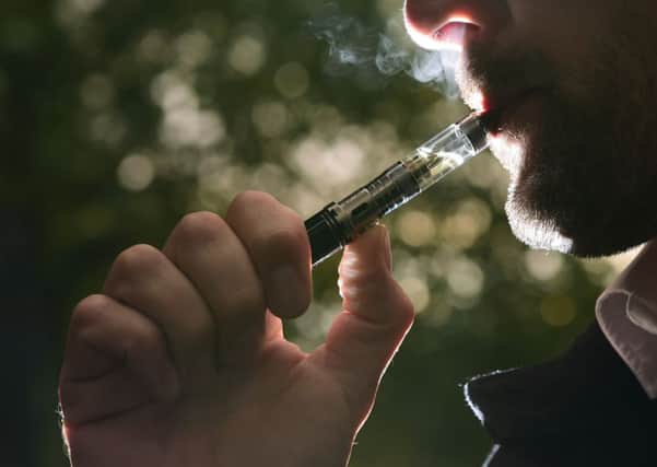 A man smokes an electronic cigarette. Picture: PA