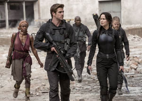 Jennifer Lawrence as Katniss Everdeen, with Liam Hemsworth as Gale Hawthorne. Picture: AP