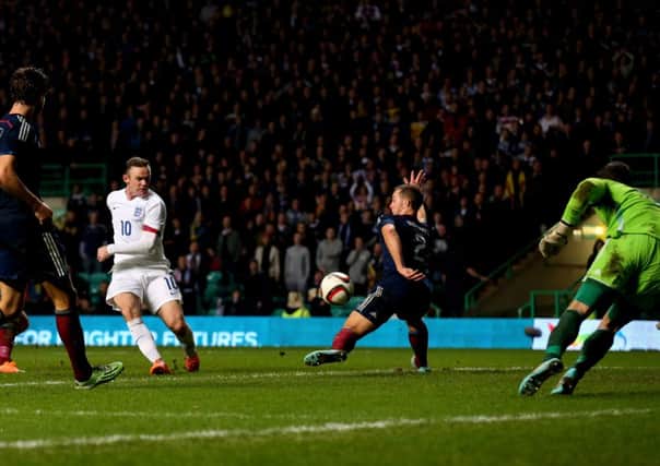 Rooney claims his second goal in the 3-1 victory over Scotland. Picture: Getty