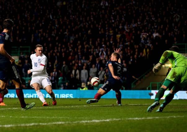 Rooney claims his second goal in the 3-1 victory over Scotland. Picture: Getty