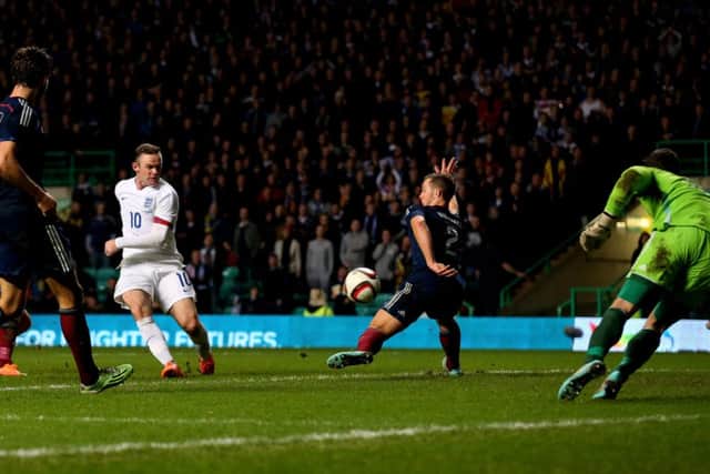 Rooney claims his second goal in the 3-1 victory over Scotland. Picture: Getty