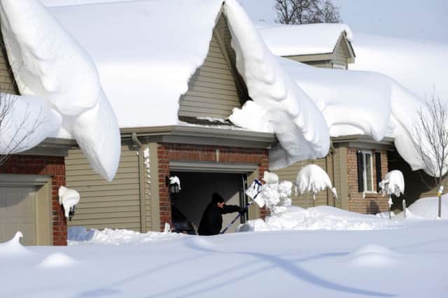 A man starts to dig out his driveway in the town of Lancaster, near Buffalo. Picture: AP