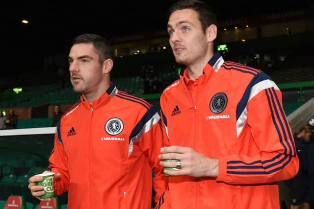 Scotland substitute goalkeepers Matt Gilks (left) and Craig Gordon enjoy a wartm drink on a cold night. Picture: SNS