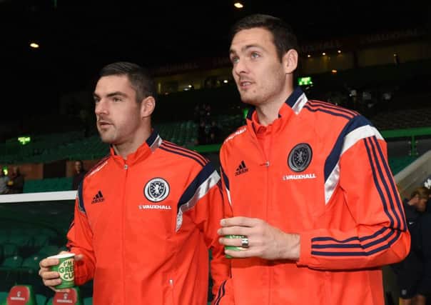Scotland substitute goalkeepers Matt Gilks (left) and Craig Gordon enjoy a wartm drink on a cold night. Picture: SNS
