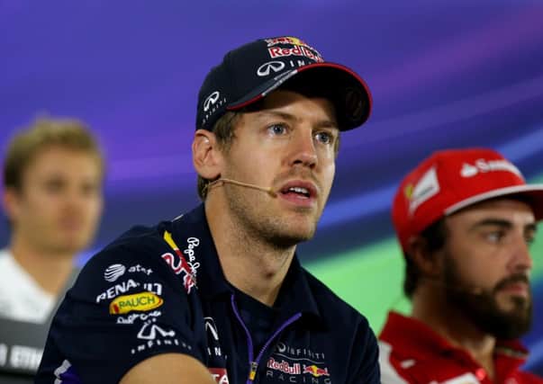 Red Bulls Sebastian Vettel, left, sits next to Fernando Alonso, the driver he will replace at Ferrari. Picture: Reuters