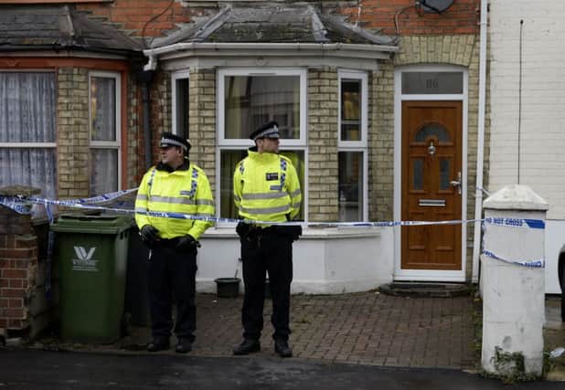 Police officers outside a house in High Wycombe as the men were arrested. Picture: PA