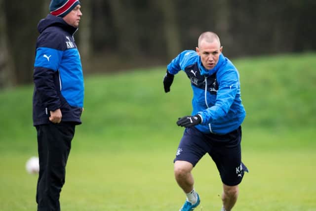 Rangers assistant manager Kenny McDowall looks on as striker Kenny Miller limbers up at training yesterday. Picture: SNS