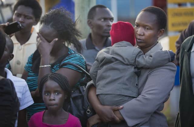 Relatives wait at Nairobis Wilson airport  for news of the return of the bodies. Picture: AP