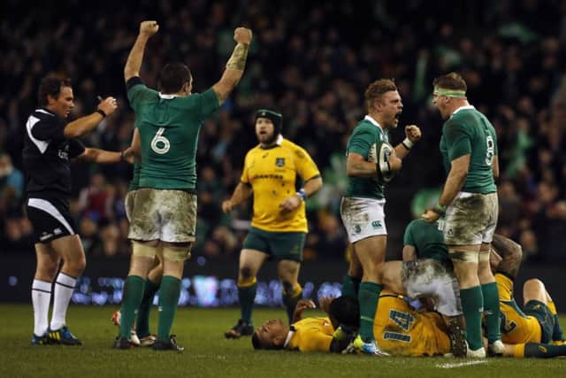 Irelands Ian Madigan, Jamie Heaslip and Peter OMahony celebrate beating Australia. Picture: Reuters