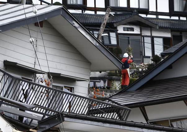 Halfcollapsed houses are surrounded by debris in the vilage of Hakuba. Picture: AFP