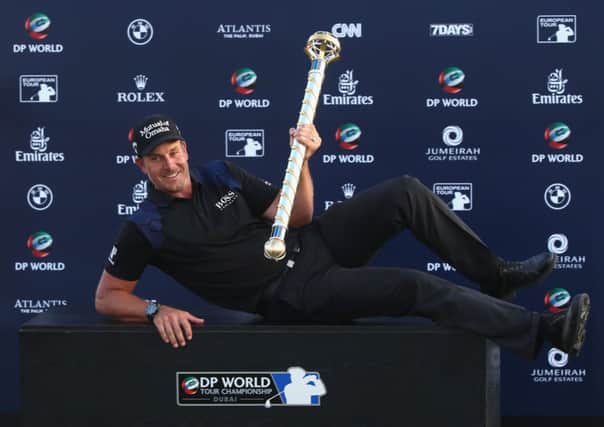 Henrik Stenson is all smiles as he poses with the trophy after coming out on top at the DP World Tour Championship yesterday. Picture: Getty