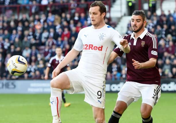 Jon Daly holds off Alim Ozturk during the Championship clash. Picture: SNS
