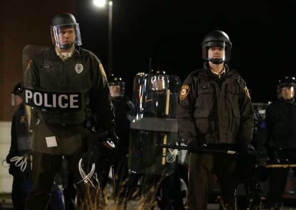 Police officers stand in front of the Ferguson police department after the grand jury's decision. Picture: Getty