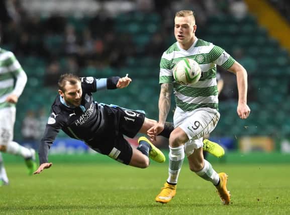 Celtic's John Guidetti (right) battles with Dundee's Kevin Thomson during the side's Scottish Premiership clash. Picture: SNS