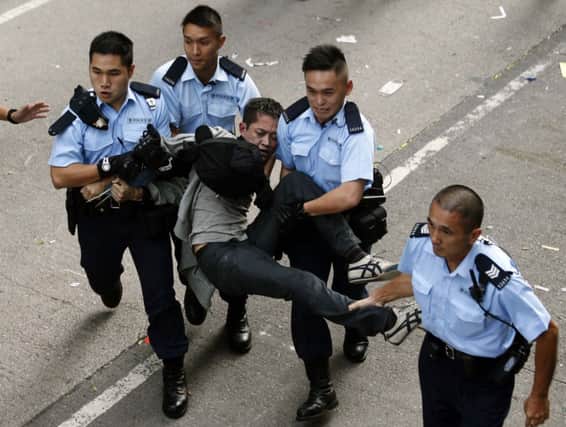 A prodemocracy protester is arrested after refusing to leave a street in Mong Kok shopping district. Picture: Reuters