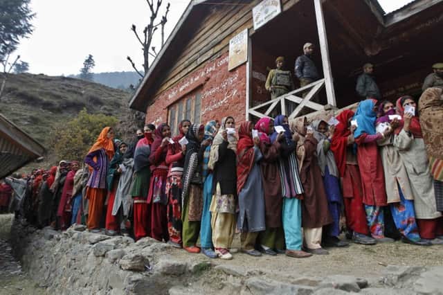 Voters queue outside a polling station for the first phase of the Jammu and Kashmir elections yesterday. Picture: Reuters