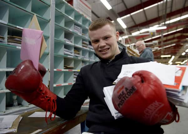 Boxer Charlie Flynn is urging people to give posties a helping hand by posting cards and presents early. Picture: Hemedia