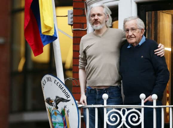 Julian Assange, left, yesterday with philosopher Noam Chomsky at the Ecuadorian embassy. Picture: PA