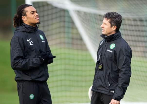 Celtic assistant manager John Collins, right, talks to Jason Denayer at training. Picture: SNS