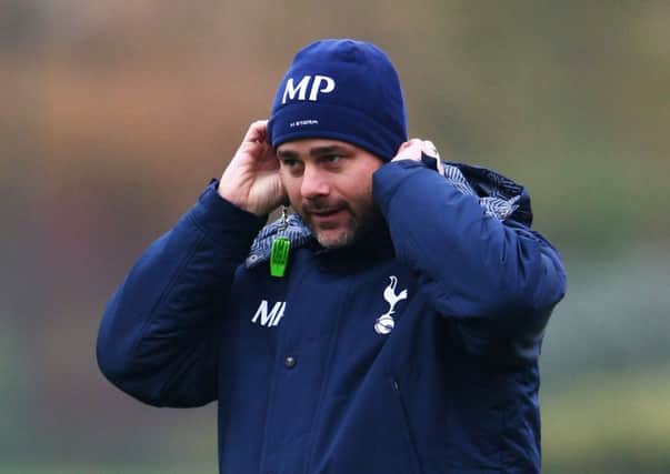 Tottenham manager Mauricio Pochettino watches his players train at Enfield yesterday. Picture: Getty