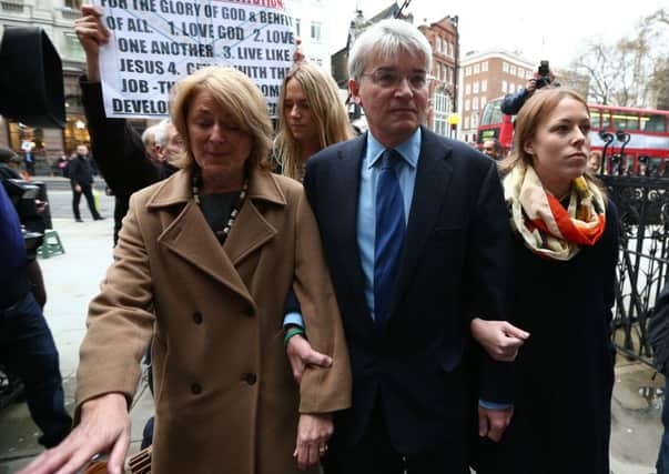 Andrew Mitchell with his wife Dr Sharon Bennett, left, and other family members arriving at the High Court today. Picture: PA