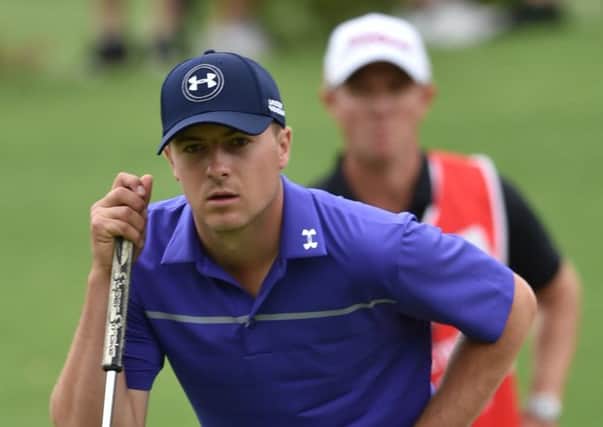 Jordan Spieth of the US lines up a putt on his way to a first-round 67 and a one-shot lead. Picture: AFP/Getty