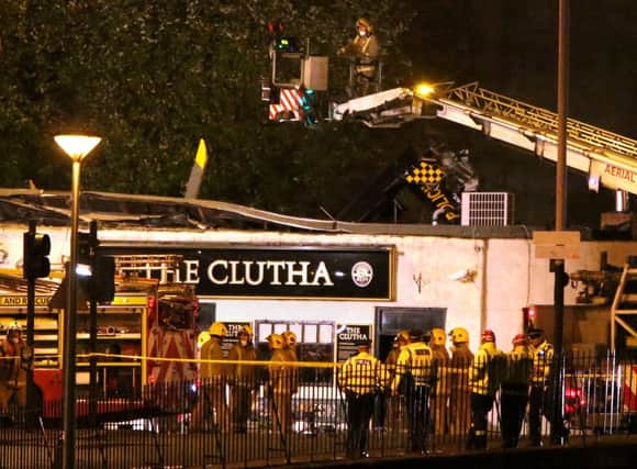 Firefighters and police survey the Clutha pub on November 30, 2013. Picture: PA