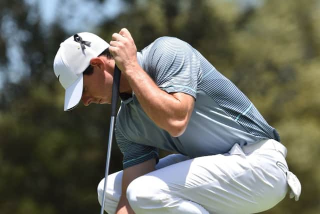 Rory McIlroy wears a black ribbon on his cap in memory of Australian cricketer Phillip Hughes. Picture: AFP