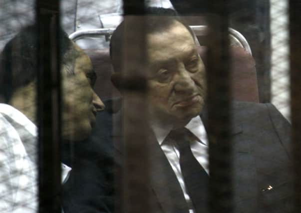 Former Egyptian President Hosni Mubarak sits in the defendants cage behind protective glass. Picture: AP