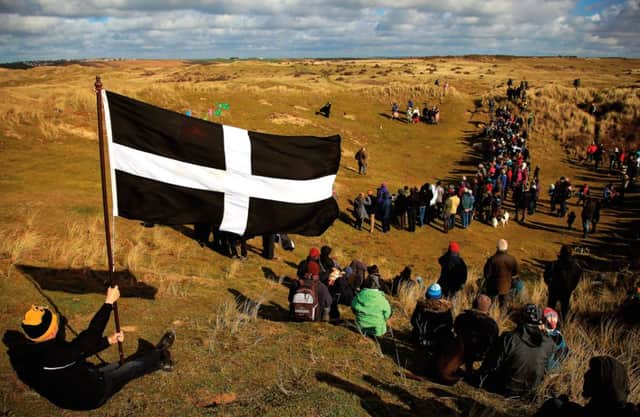 A Cornish flag is held at the annual procession for St Piran in Perranporth. Picture: Getty