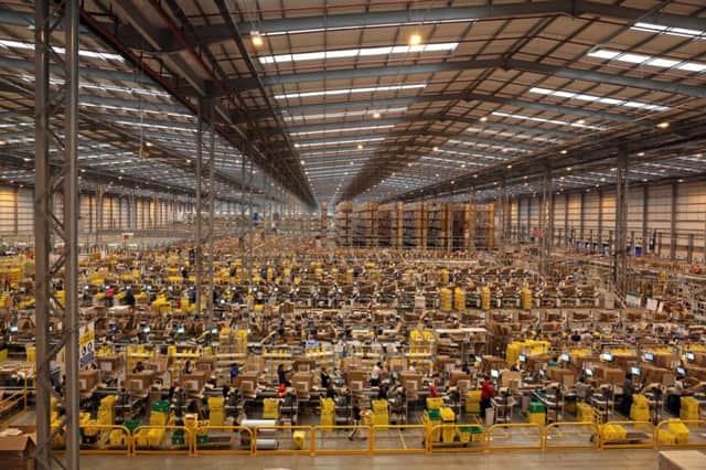 Staff pack orders at the Amazon UK Fulfilment Centre in Peterborough. Picture: PA