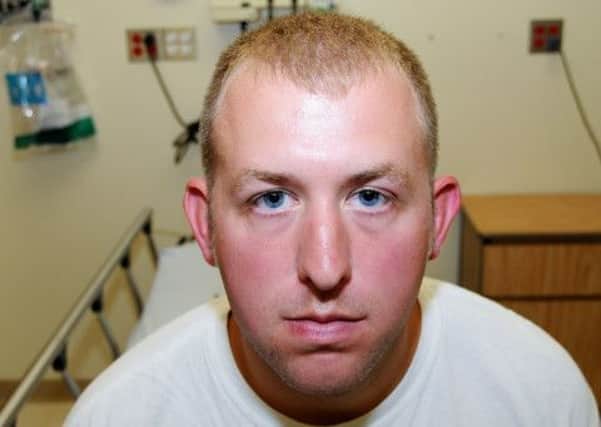 Ferguson police officer Darren Wilson during his medical examination after he fatally shot Michael Brown. Picture: AP