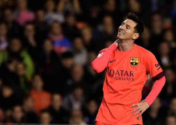 Lionel Messi was celebrating Barcelona's winner when he was struck by a bottle. Picture: Getty
