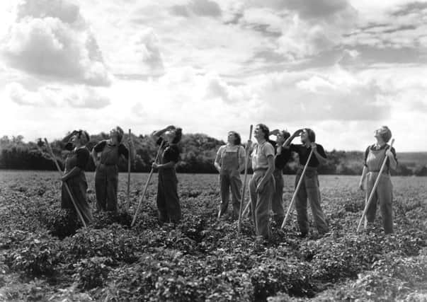 On this day in 1941, all single women in Britain between 20 and 30, such as these land girls, were called up for war work. Picture: Getty