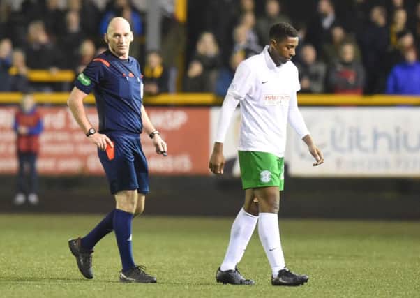 Dominique Malonga trudges off after being shown the red card by Bobby Madden. Picture: SNS