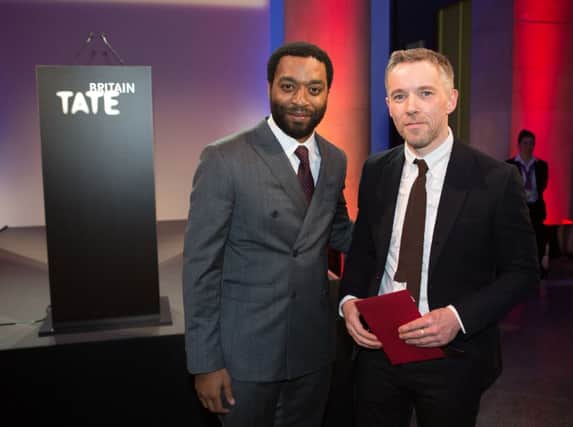 Actor Chiwetel Ejiofor presents Duncan Campbell with this year's Turner Prize. Picture: PA