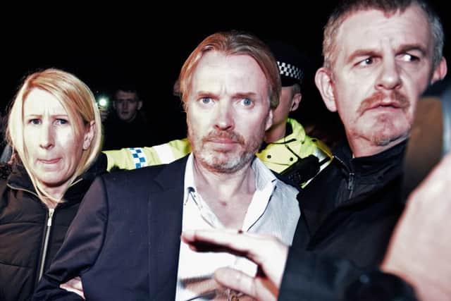 Former Rangers owner Craig Whyte is surrounded by police after being released on bail following a court appearance. Picture: Getty